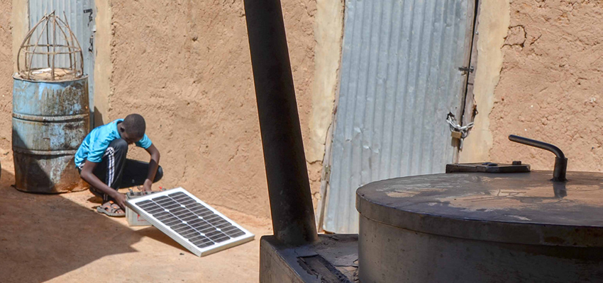 Young man with solar panel, Mali.