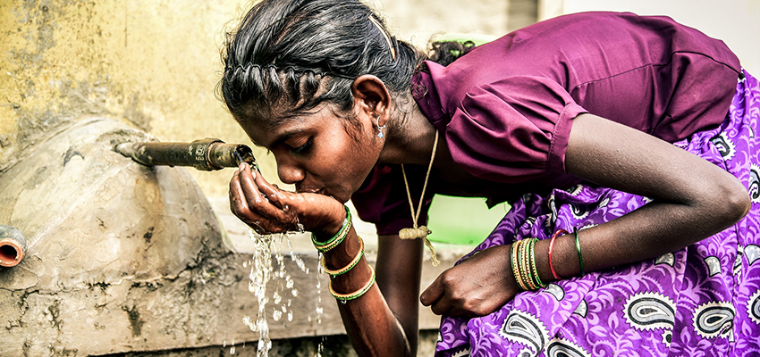 Girl drinking water from a community water tank in Bangalore. Photo: Megha Hegde