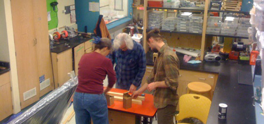 Amy, Dennis and Eric working on the poster boards in D-Lab.