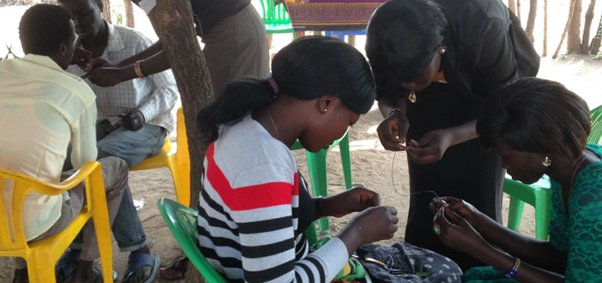 Teenagers in the Ayilo refugee settlement in Uganda build their own lights to read at night.