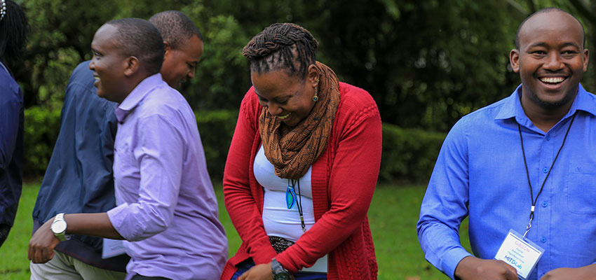 Summit participants, Peter Mumo, Noeline Kirabo and Gibson Muriuki share a laugh during morning circle