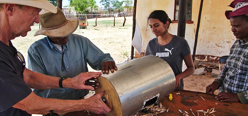 D-Lab Student and community members working on a bean thresher, Dutlwe, Botswana, in January of 2019.