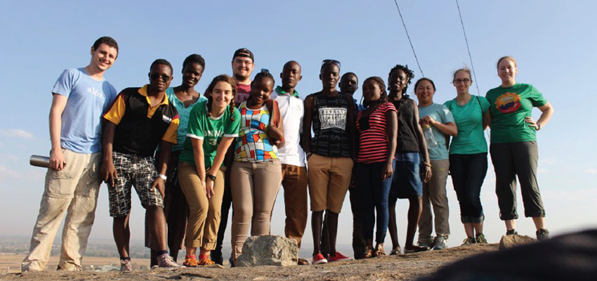 A team of MIT D-Lab and akerere University students, and TEWDI staff members, pose for a picture at the top of Soroti Rock. Photo: Lauren Bustamante