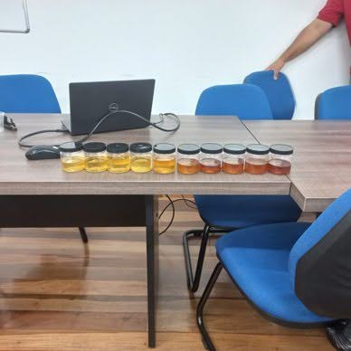 Small jars of honey on a table for testing.
