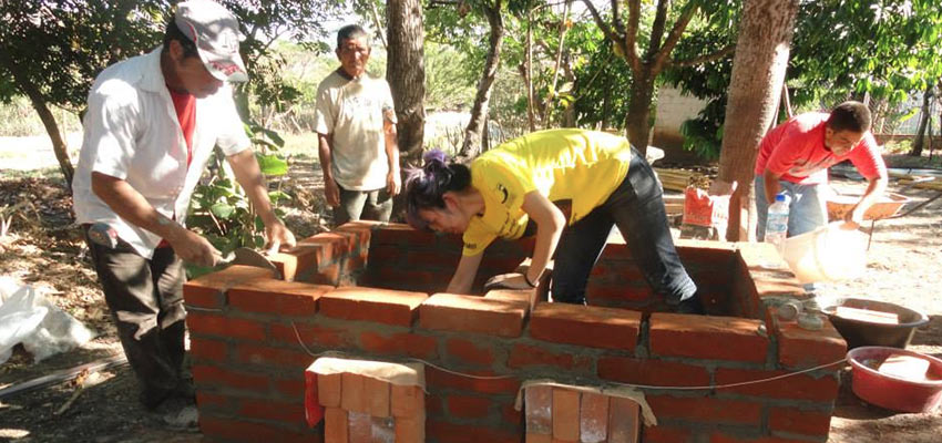 several people building brick structure