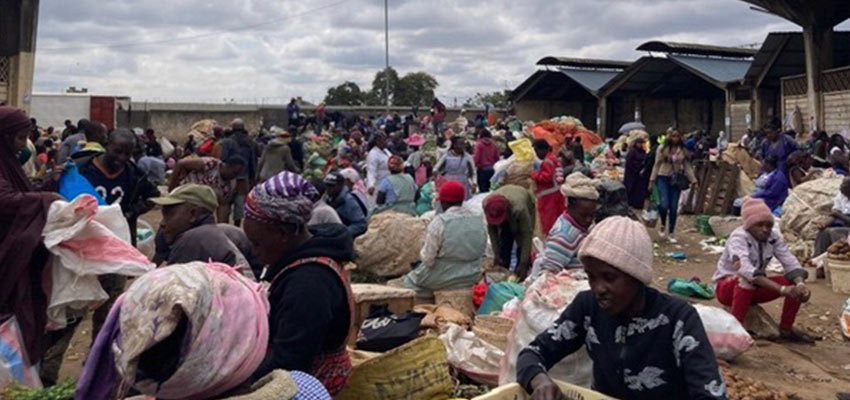 Many people in an Kenyan open-air market.