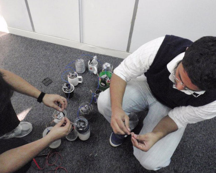 Syed and Ali connecting aluminum can batteries