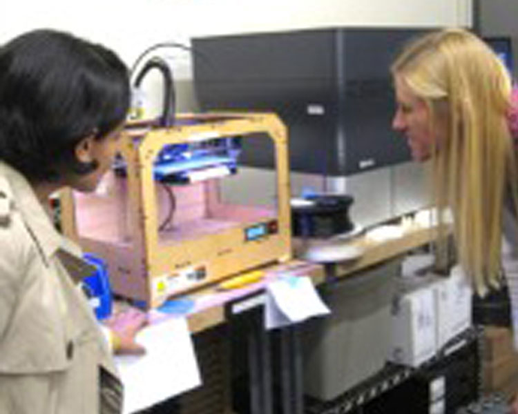 Shweta Sharma (left) and Danielle Zurovcik (right) are using a 3D printer to print initial concept models for a discussion on Shweta’s thesis work at MIT Sloan, which is focused on the Wound-Pump business model.