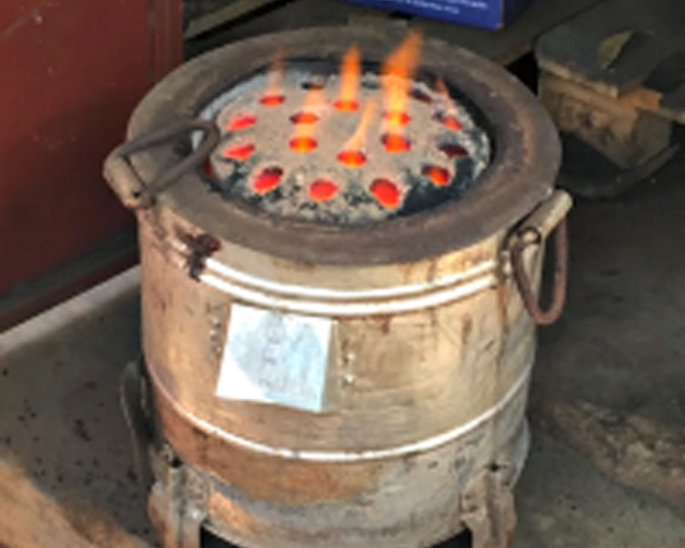 An example of a “honeycomb” briquette. These briquettes are named for their shape, which allows for easy channeling of flames during use. 