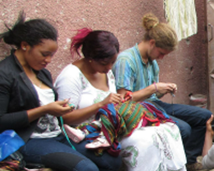 Crocheting with community members. Trip co-leader Nani Ruiz at right.