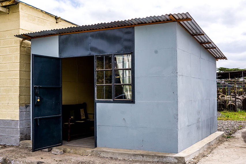 Kwangu Kwako Limited’s 12’x12’ show house, demonstrating its secure metal door and sturdy modular concrete design