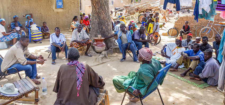 Mercy Corps' Sory Mariko discussing the energy needs with community leaders in the village of Tiby, Mali.