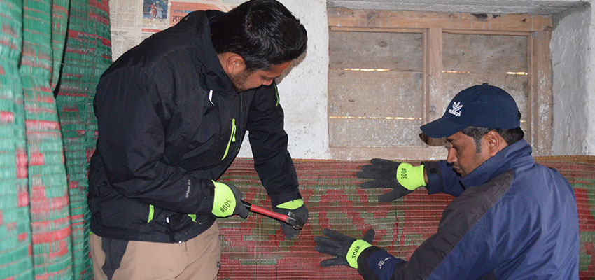 Bhuwan and Shailendra Sir working to nail the chatai panels into the wall, which was particularly hard because the walls are composed of stone and mortar.