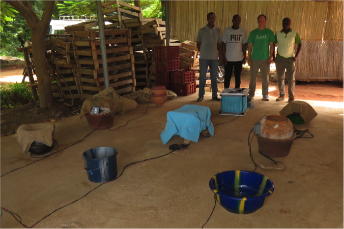 Research team and clay pot cooler experimental setup