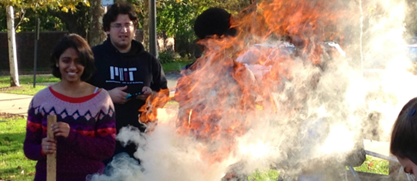 D-Lab students make charcoal from agricultural waste at the MIT Kresge Barbecue Pits.