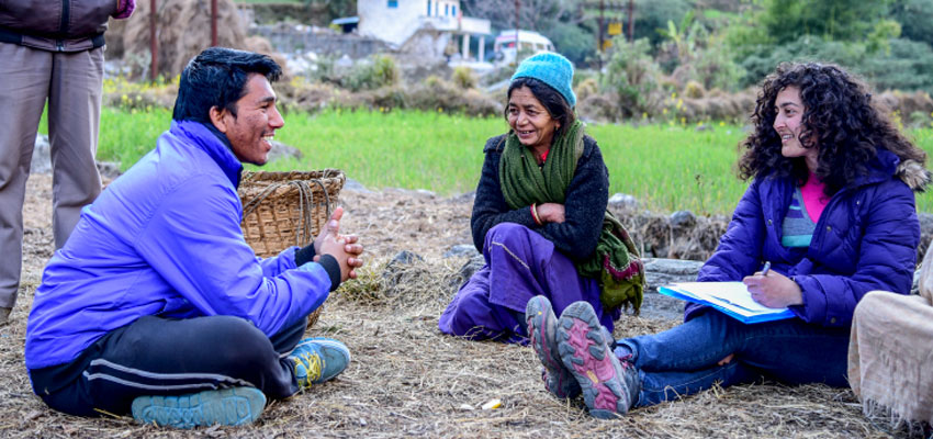 Nupur (right) and her translator Deepak Bhatt (left) interviewing a woman in a village in Bageshwar district of Uttarakhand (center).