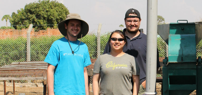 Left to right: Drew Beller '18, Joy Lee '13, and Tim Mangenello '17 stand proudly by a completed charcoal grinder. Photo: Lauren Bustamante