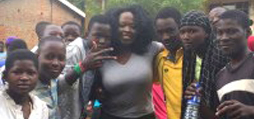Nai Kalema in Jinja, Uganda, with students from St. Stephen's School.