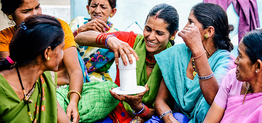Women holding prototype of xylem water filter, India, 2018.