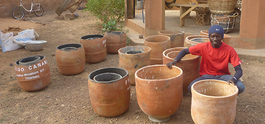 Oumaro Barry with clay pot coolers in Burkina Faso; Photo Credit: Peter Rinker
