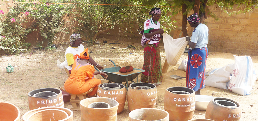 Women with pot-in-pot evaporative coolers, Burkina Faso.