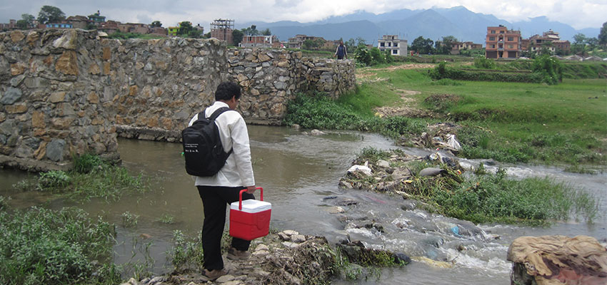 Carrying the PortaTherm cooler. Nepal.