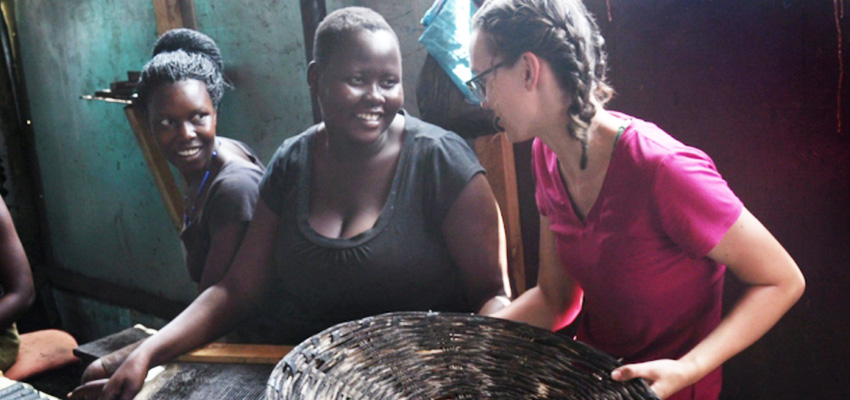 Senior Danielle Gleason (right) speaks with Goretti Ariago (center) and Salume Awiyo (left), employees of Appropriate Energy Saving Technologies, in Soroti, Uganda. Gleason has made two trips to Uganda to help streamline the production of charcoal briquettes which offer a low-smoke alternative for home cooking fuel. Photo: John Freidah 