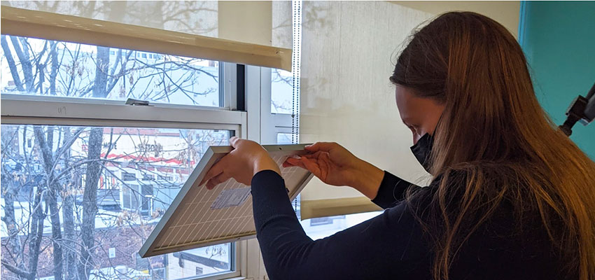 Fig. 1 Audrey holds up a solar panel for UVC prototype (Photo courtesy of Audrey Leibig)