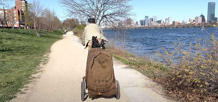 Cameron riding a bike with our cooling trailer attachment (canopy removed for testing) along the Charles River. Photo: Courtesy MIT D-Lab