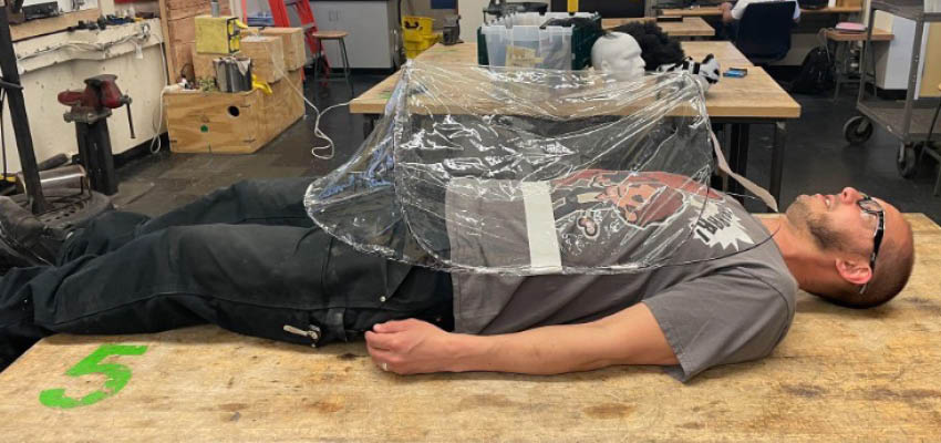 One of two of our initial prototypes, which is a pop-up design made from spring steel and sheets of TPU sewn together, graciously modeled by Jack Whipple, D-Lab workshop manager. Photo: Alex Lee)