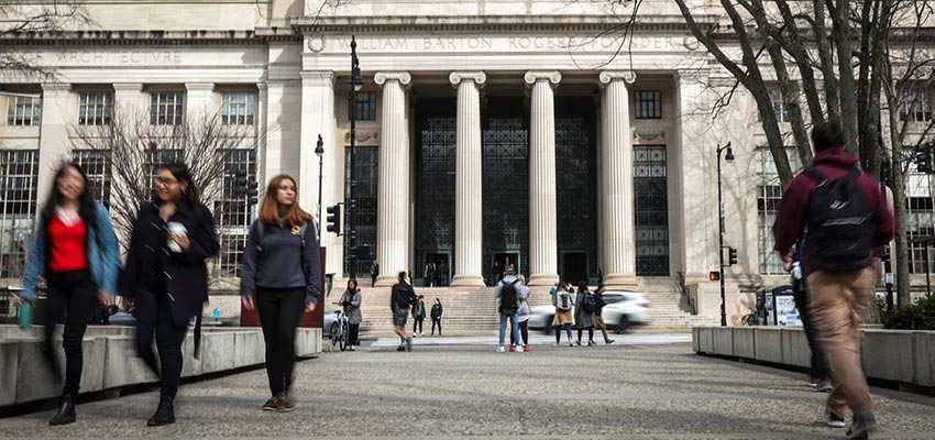 People walk though MIT’s campus in Cambridge, Mass. Credit: Erin Clark/The Boston Globe via Getty Images