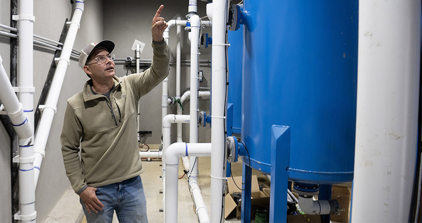 Seth Summerside, CEO of Keo Fish Farms points to one of the tanks of the filtering system that they installed with the Massachusetts Institute of Technology Thursday, April 2, 2026 at Keo Fish Farms in Keo. Photo: Arkansas Democrat-Gazette/Adam Vogler