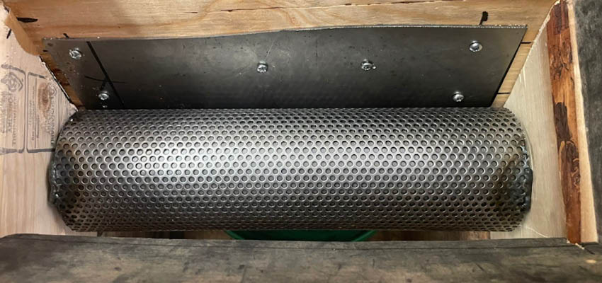 perforated metal roller viewed from above.