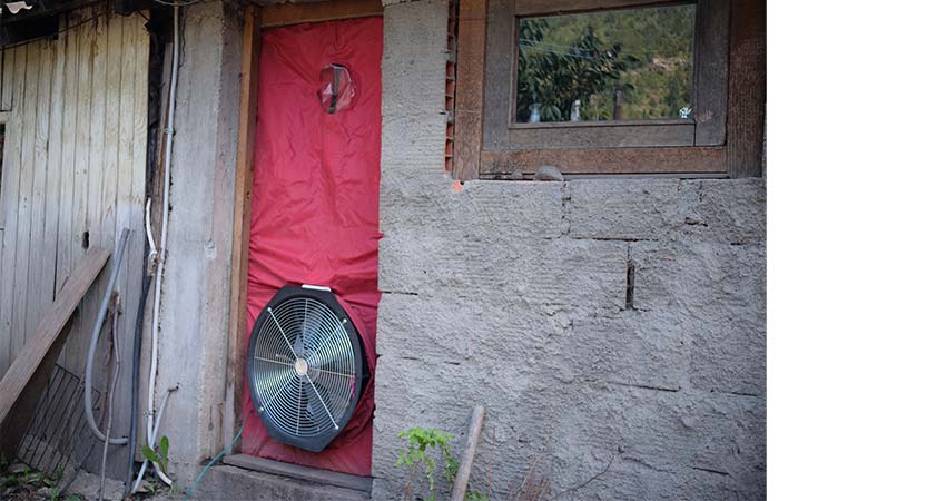 Large round fan inserted in an exterior door.
