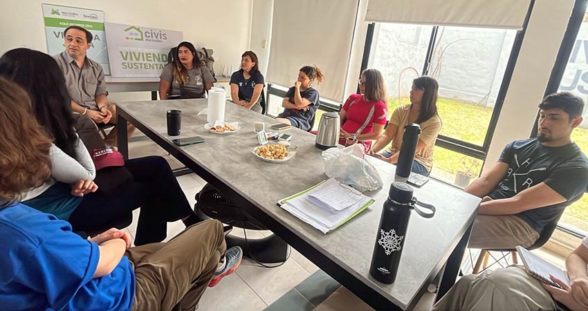 Half dozen people sitting around a conference table.