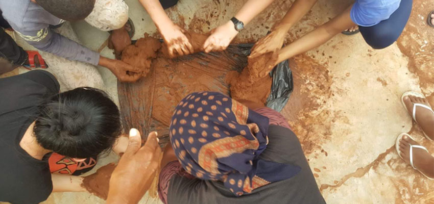 The community working together to create clay for pots