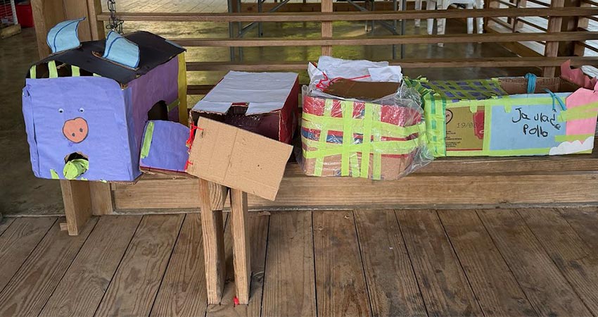 A group of decorated cardboard boxes on a bench.