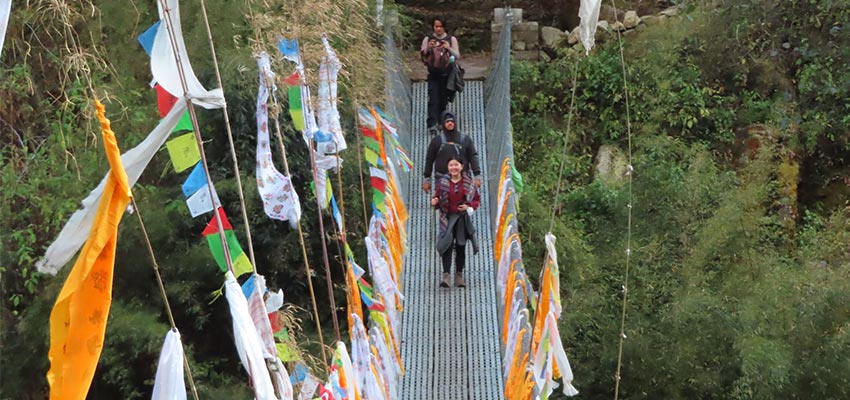 Crossing a river on a swaying bridge in the Langtang Valley in Nepal. 