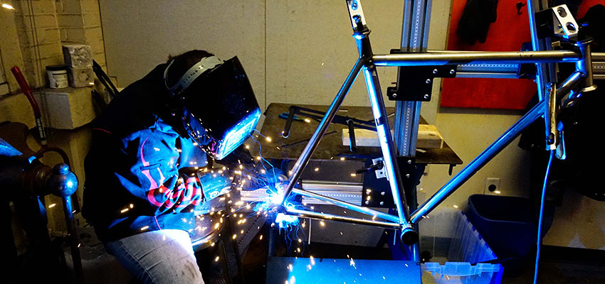 woman welding bike frame