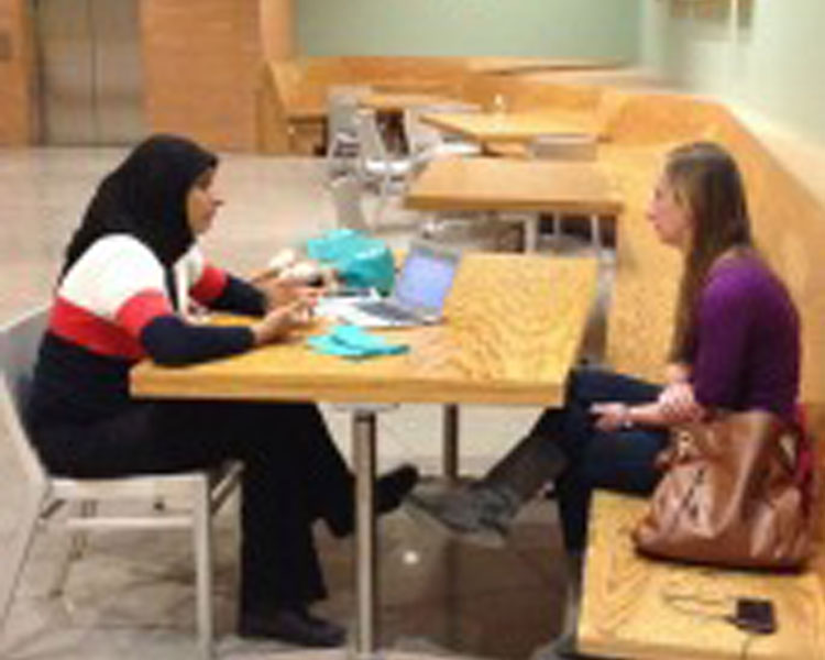 D-Lab Scale-Ups fellow Zubaida Bai (left) chats with conference attendee (right)