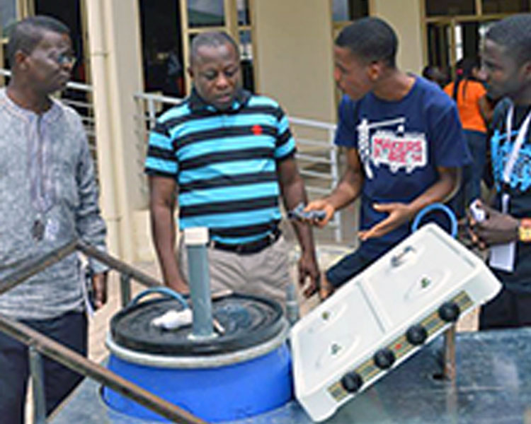Student participants at the GESA Maker Faire in Accra, Ghana display their prototype.