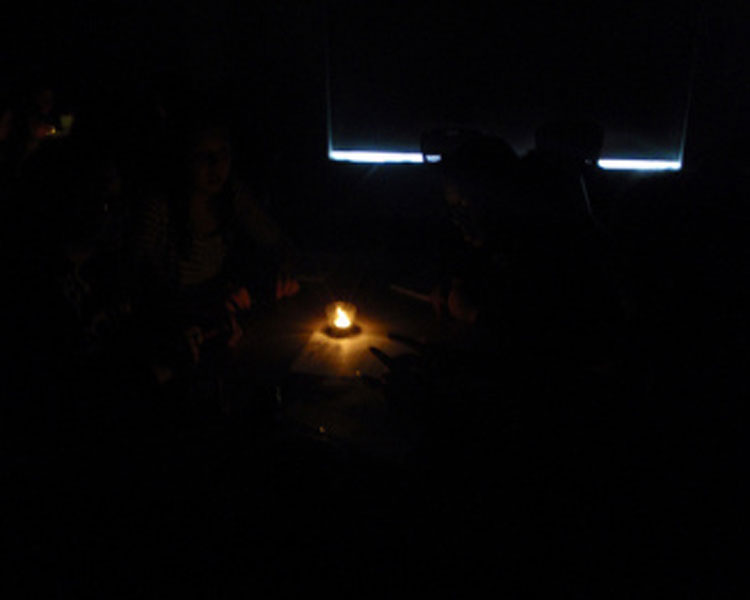 First, they took a group quiz by candlelight -- one tealight candle per group of four students taking the quiz. As you can see, these were VERY challenging conditions.
