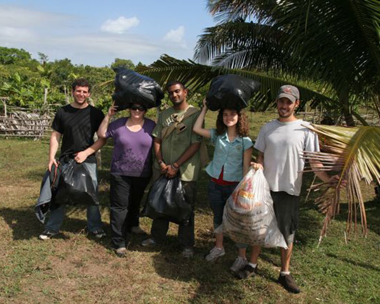 Carrying the coconut husks for the burn. A great charcoal burn in which we learned that coconut husks carbonize absolutely brilliantly, and that people in this deforested region are PSYCHED for charcoal.