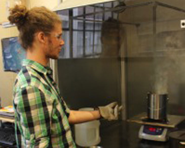 D-Lab UROP Nani Ruiz tests a mini kiln in the fuel test facility.