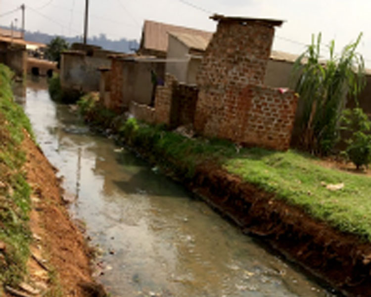 Plastic and chemical waste polluting a stream in an industrial area of Kampala.