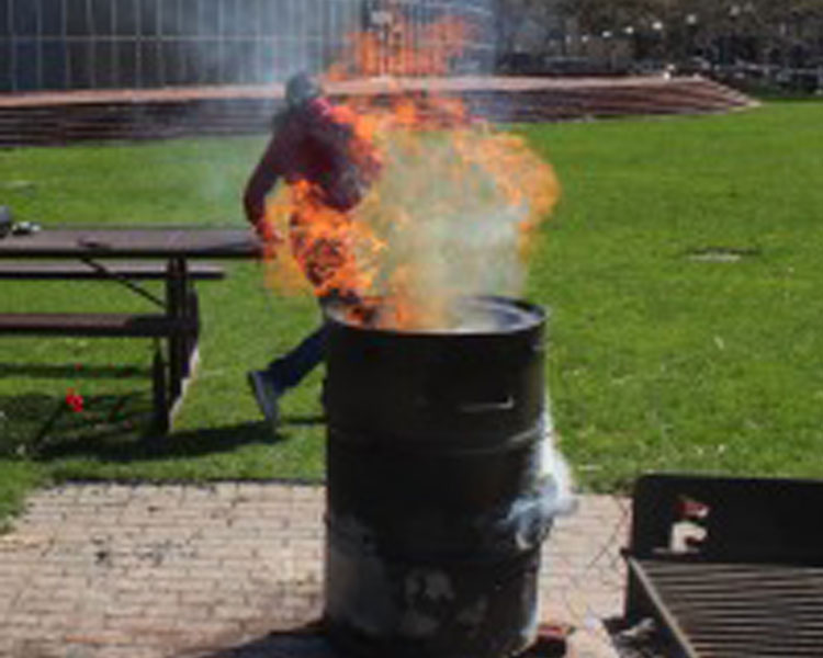 MIT Engineers Without Borders students fire an MIT kiln at Kresge Lawn.