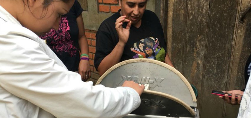 Isabel shows off her honey centrifuge. Photo courtesy of FEM