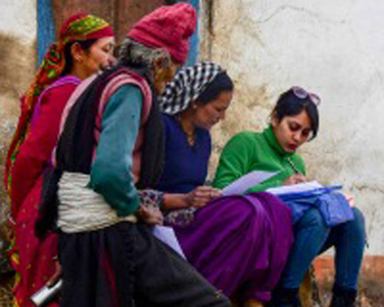 Megha Hegde conducting interviews with women in a village.