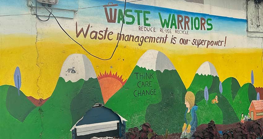 Mural of mountains with the words, "Waste Warriors, waste management is our superpower!"