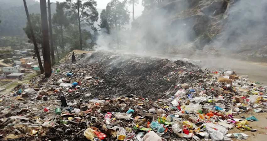 Curving roadside littered with trash.